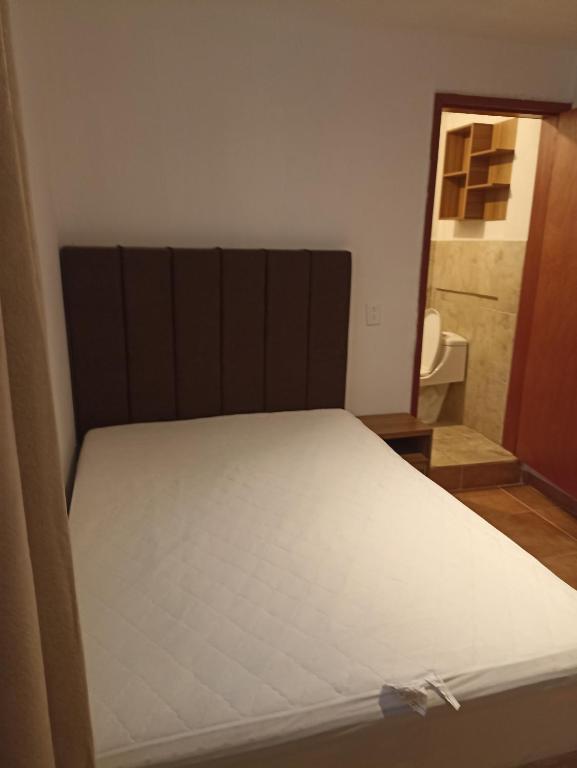 a bed in a small room with a mirror at Alojamiento Querétaro in Salitre
