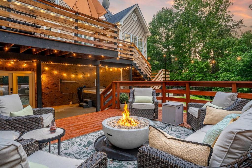 a patio with a fire pit on a deck at Trailside Country Haven in Bagdad
