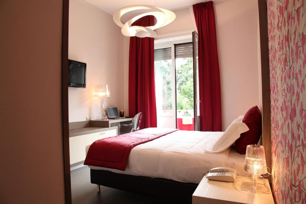 Postel nebo postele na pokoji v ubytování Hotel Tiziano - Gruppo Mini Hotel