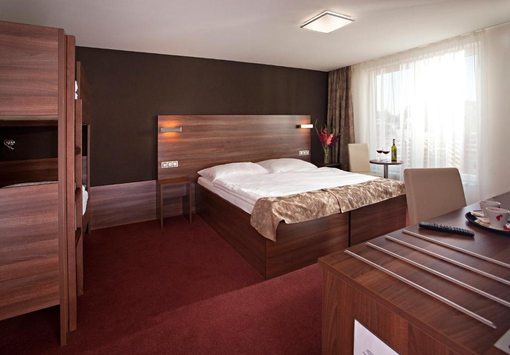 Postel nebo postele na pokoji v ubytování Hotel Termal Mušov