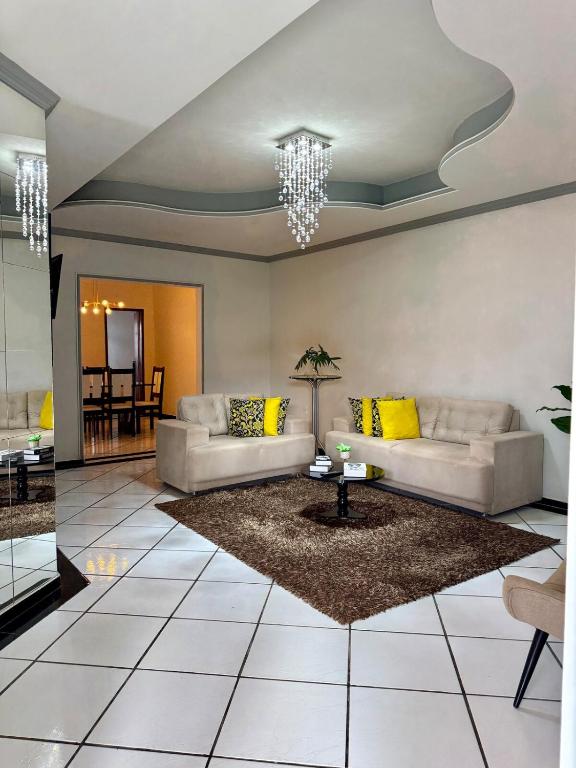 a living room with two couches and a table at Casa do umbuzeiro in Bom Jesus da Lapa