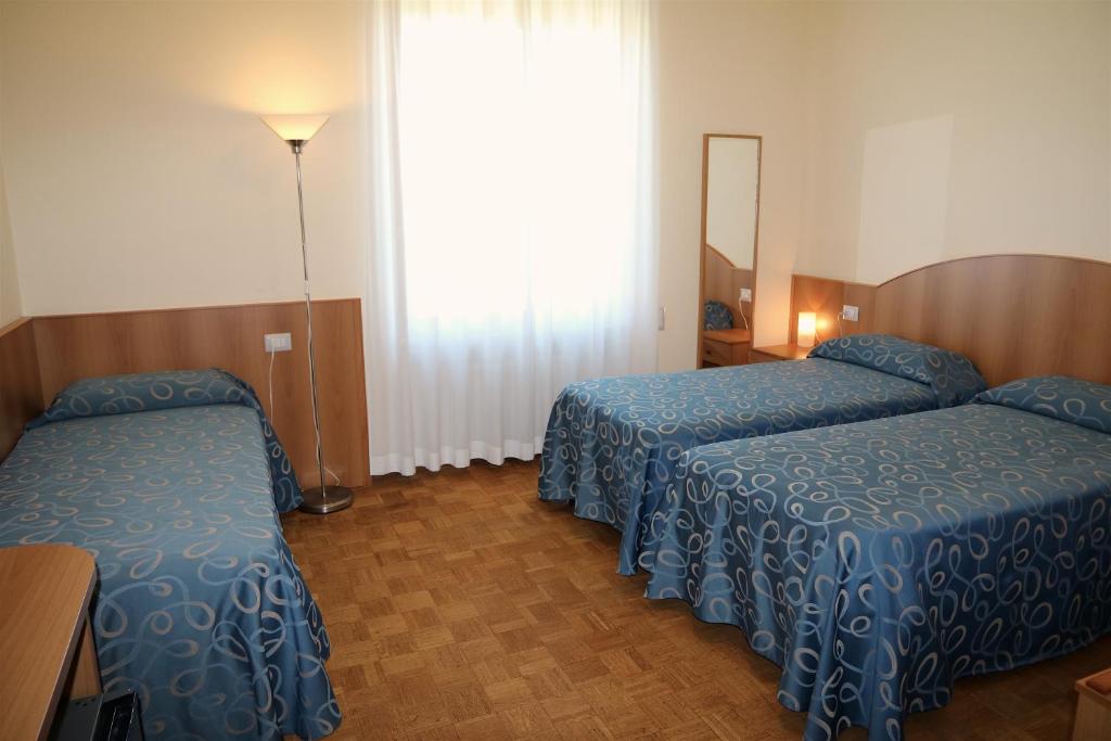 Postel nebo postele na pokoji v ubytování Hotel Palladio