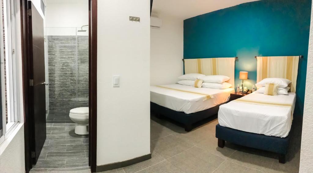 Postel nebo postele na pokoji v ubytování Nueve Agaves Hotel