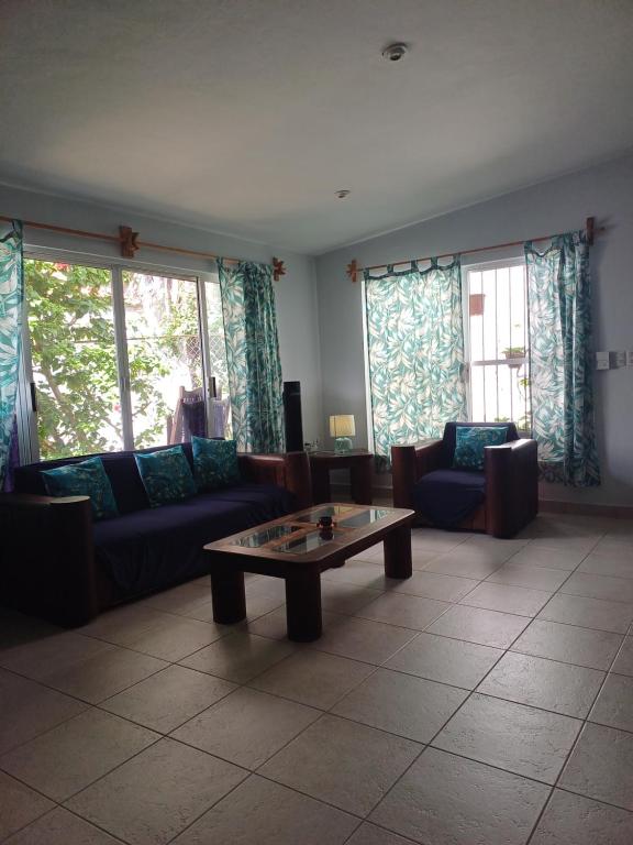 a living room with a couch and a coffee table at Tziimin Nahil Cozumel in Cozumel