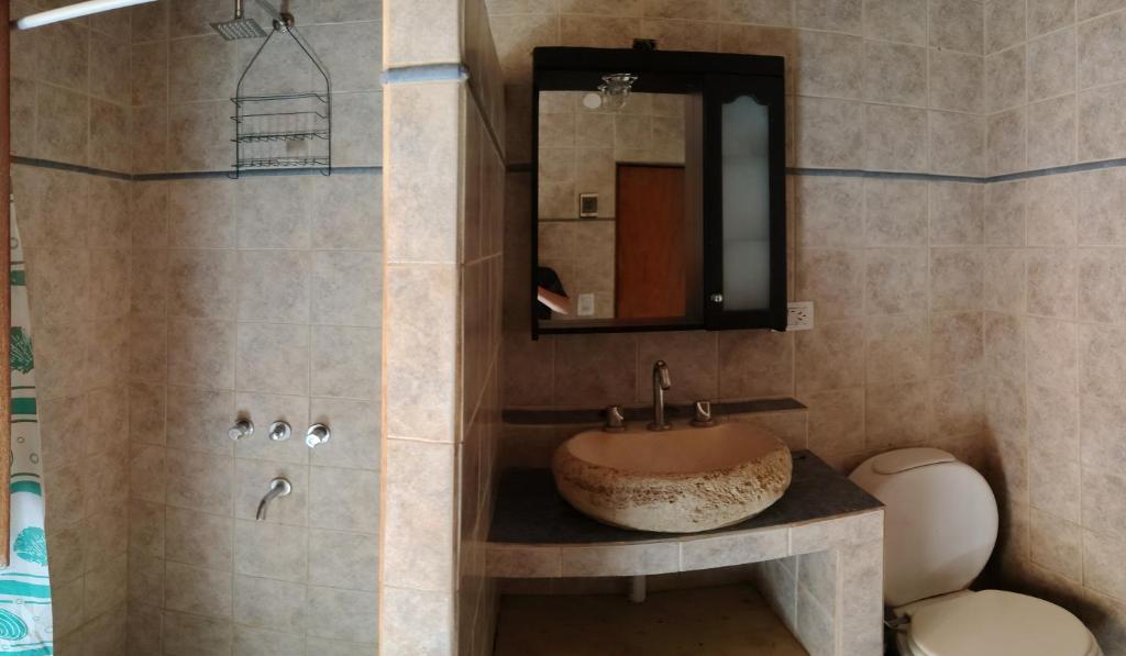 a bathroom with a sink and a mirror at La Casa Azul in San Javier