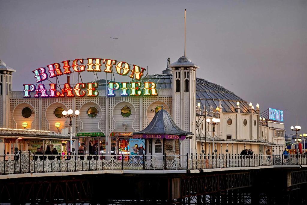 a carnival park with a large building with a sign at Bright and Spacious 2BR Maisonette Sleeps 8, Game Room, 5 mins to Brighton Beach and City Centre in Brighton & Hove