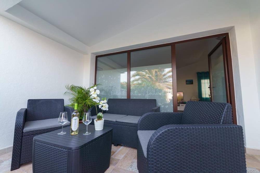 a patio with chairs and a table with wine glasses at Casa Conchita - Los Cancajos in Los Cancajos