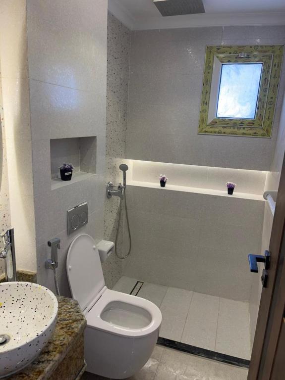 a bathroom with a toilet and a sink at Amoun sea view in Qaryat Shurūq