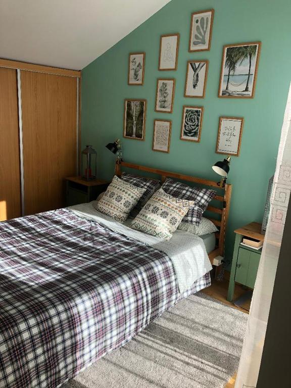 a bedroom with a bed and a wall with pictures at Alojamiento rural con encanto in Alborache