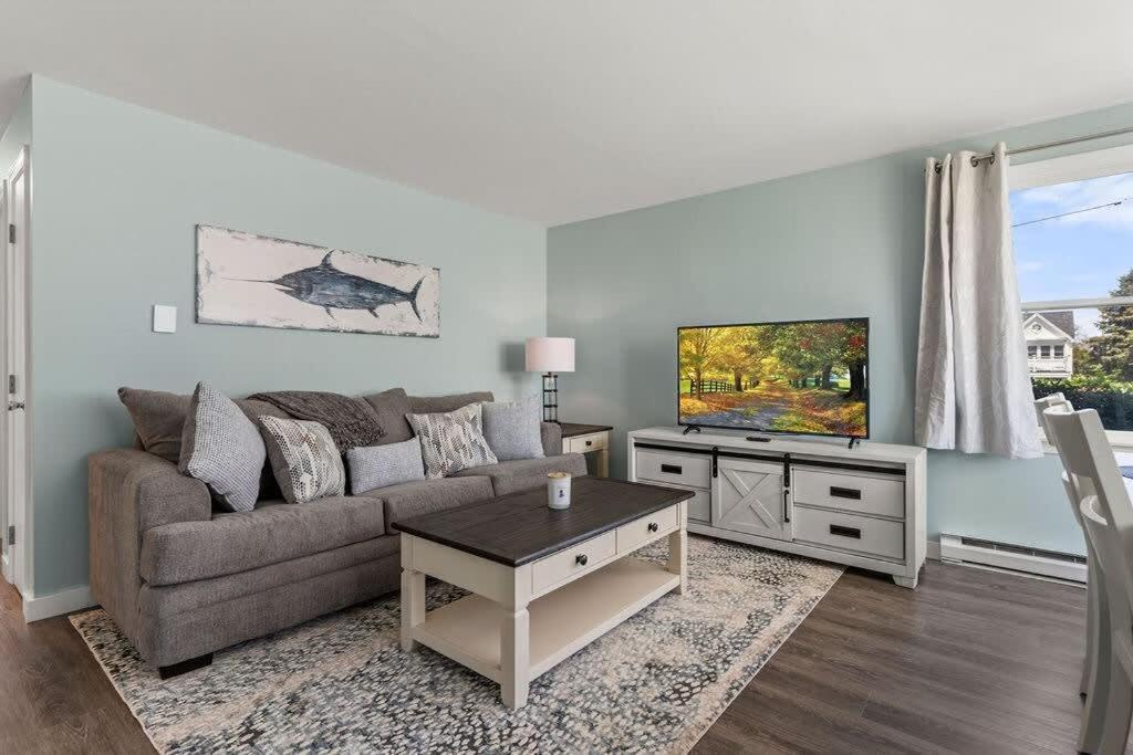 a living room with a couch and a tv at Harbor Serenity Private Deck Updated Kitchen in Rye
