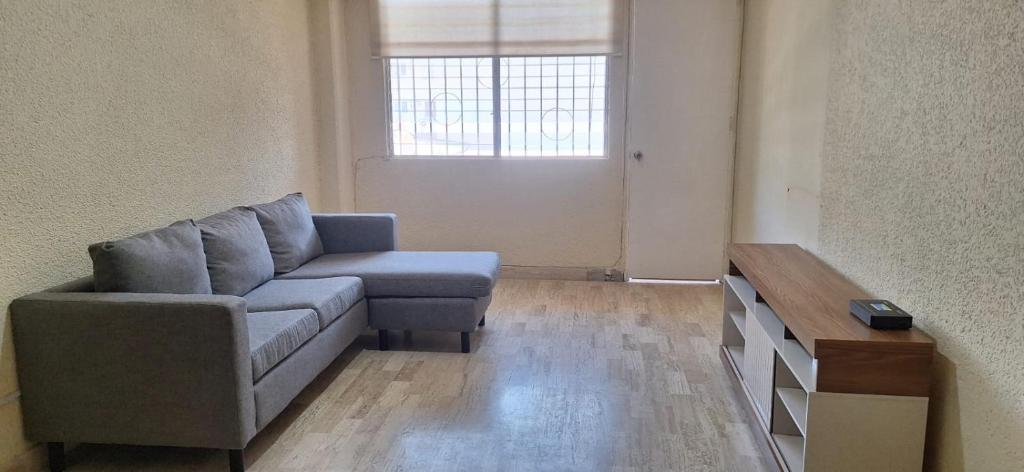 a living room with a couch and a table at Apartment on the French Riviera in Acapulco
