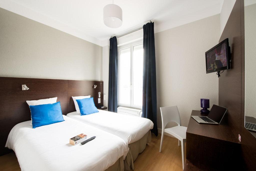 Postel nebo postele na pokoji v ubytování Hôtel Atrium