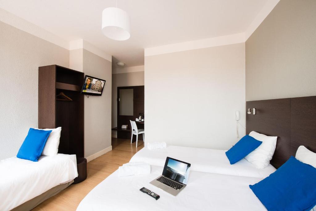 Postel nebo postele na pokoji v ubytování Hôtel Atrium