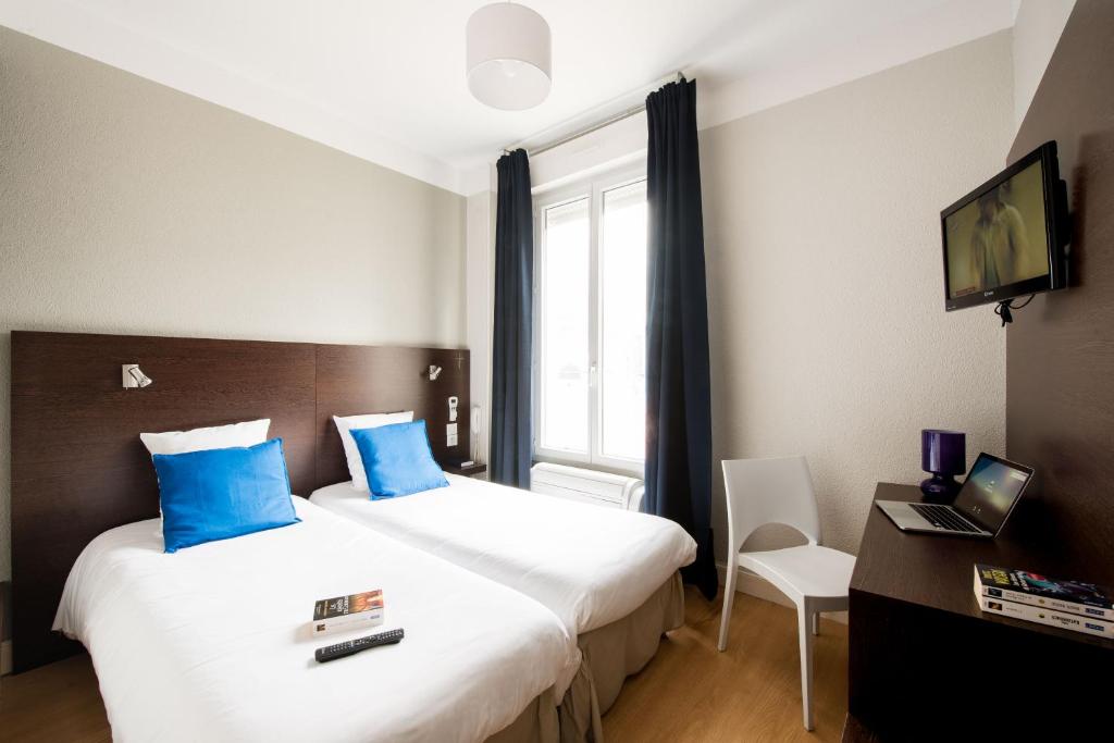 Postel nebo postele na pokoji v ubytování Hôtel Atrium