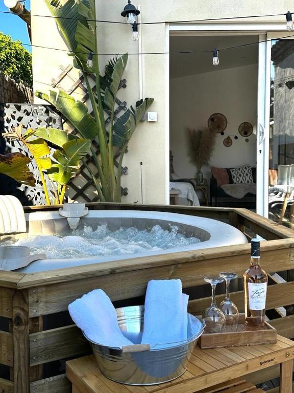 un jacuzzi avec un bol d'eau et deux verres dans l'établissement Superbe dépendance Sanary, studio jacuzzi privé, à Sanary-sur-Mer