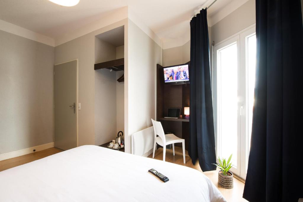 Postel nebo postele na pokoji v ubytování Hôtel Atrium
