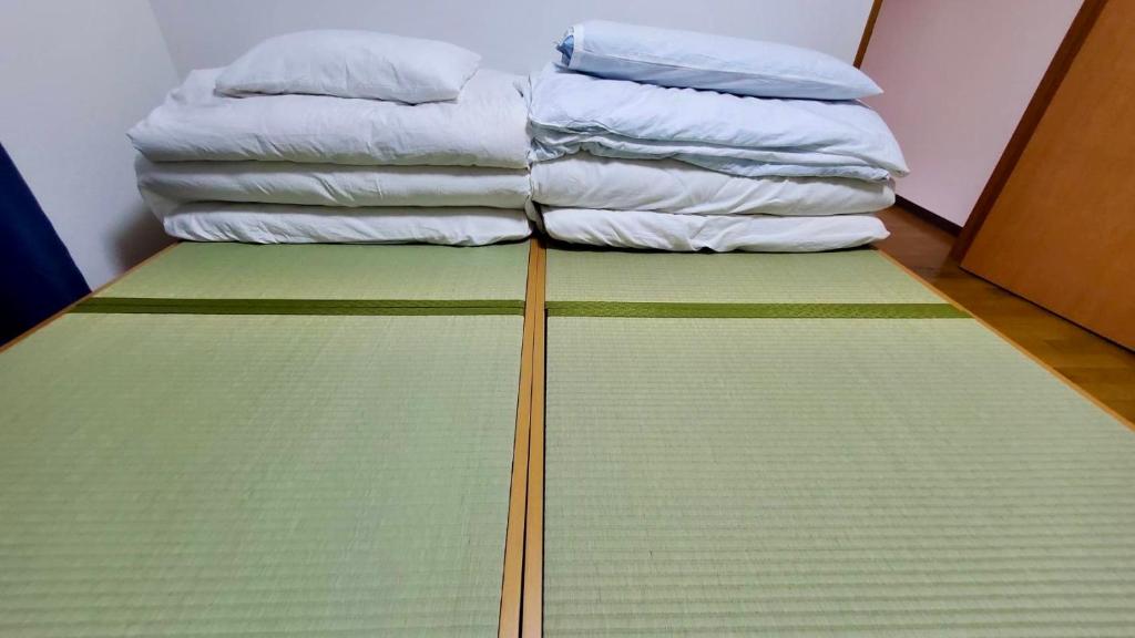 Postel nebo postele na pokoji v ubytování Iruma INN