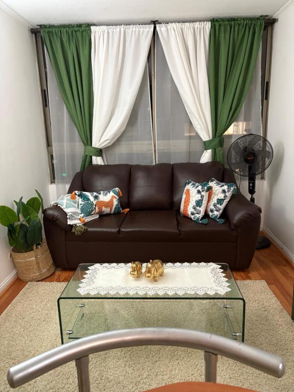 a brown couch in a living room with a coffee table at Apartment in Santiago-Catedral in Santiago