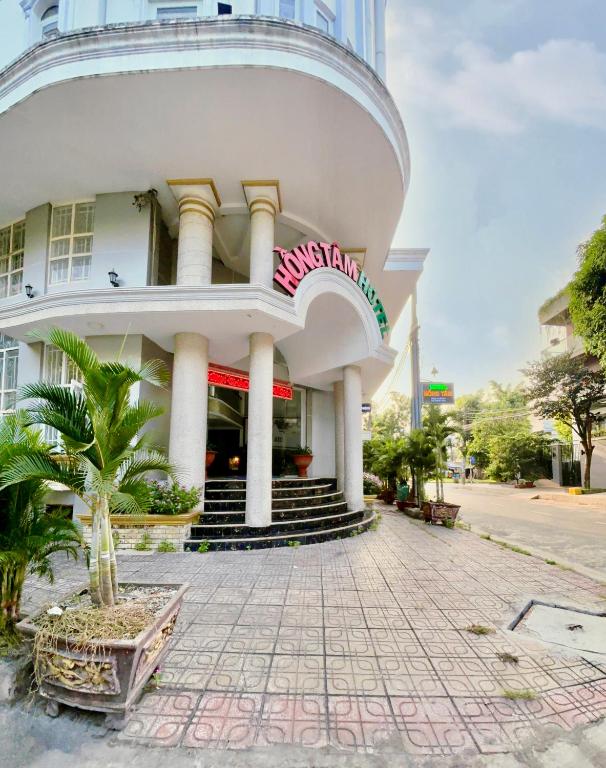 a building with a spiral staircase in front of it at Hong Tam Hotel in Ho Chi Minh City