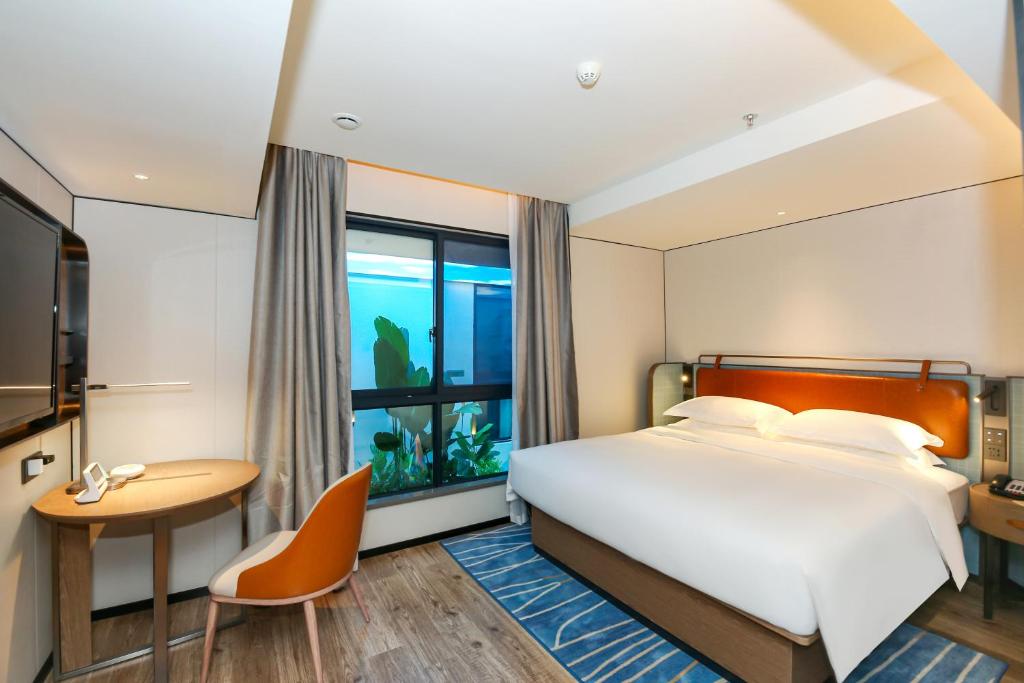 Postel nebo postele na pokoji v ubytování Echarm Hotel Guangzhou Dongpu Financial City Pazhou Convention Center - Free shuttle bus for Canton Fair
