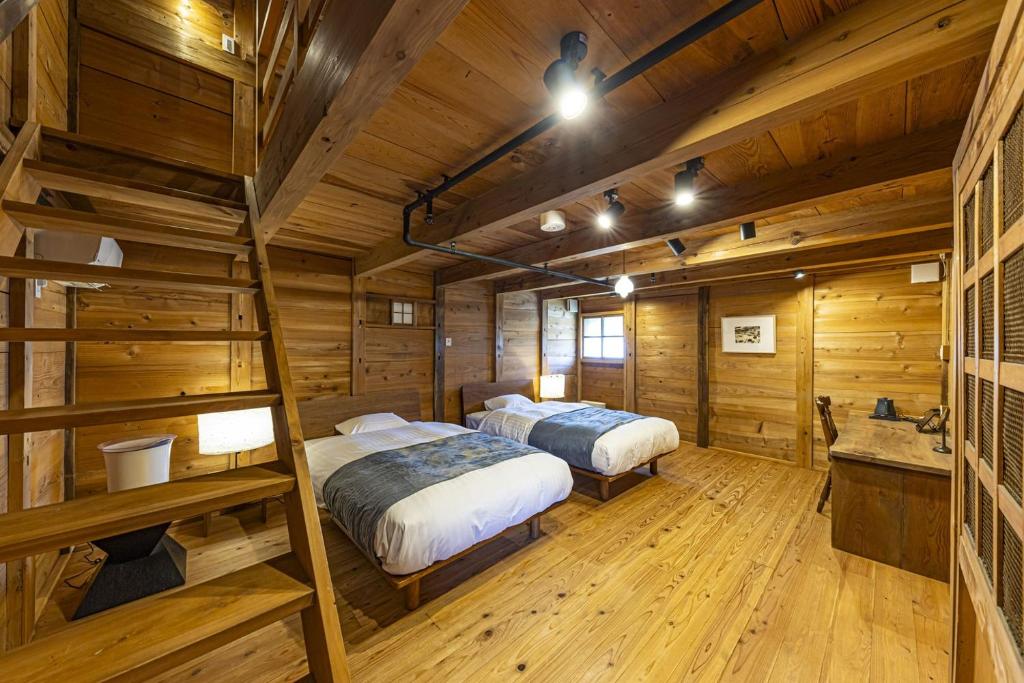 Postel nebo postele na pokoji v ubytování NIPPONIA 福住 宿場町