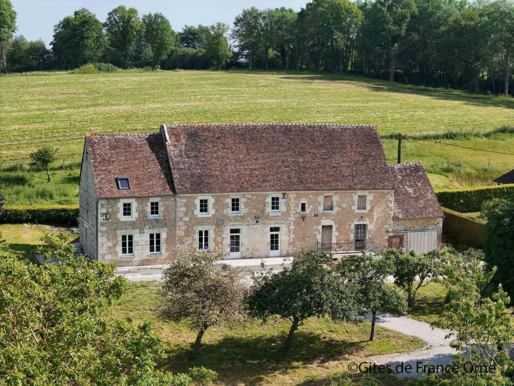 une ancienne maison en pierre dans un champ arboré dans l'établissement Maison de charme avec babyfoot et jardin au cœur du Perche - FR-1-497-243, à La Ménière