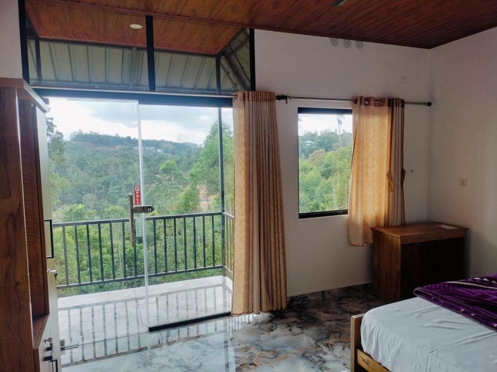 a bedroom with a large window with a view at Half moon holiday home - 4 Bedroom Villa in Anachal
