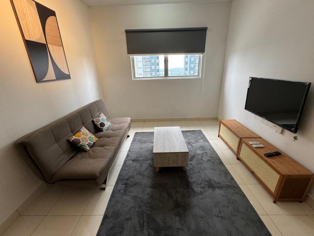 a living room with a couch and a tv at Alanis Suite Homestay Fully Air-Con Suite Nilai KLIA in Sepang