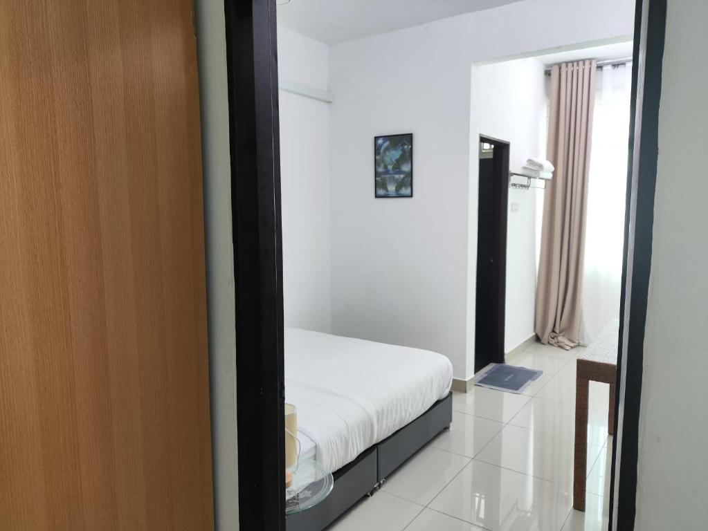 Postel nebo postele na pokoji v ubytování Homestay Studio Apartment Bentara Suite, Kompleks Mutiara Gua Musang