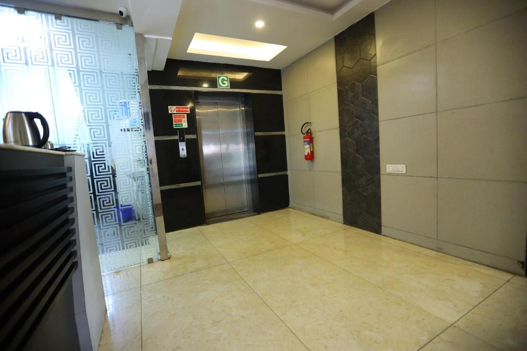 a hallway with a elevator and a door in a building at Hotel Starlight Chennai near DLF,L&T,Miot,Tradecenter,Ramachandra medical coll in Chennai