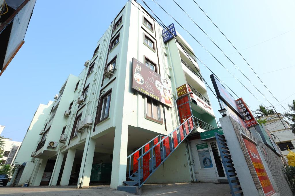 a white building with a sign on the side of it at Hotel Starlight Chennai near DLF,L&T,Miot,Tradecenter,Ramachandra medical coll in Chennai