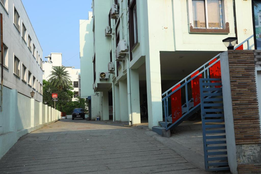 an alley with a blue staircase in a building at Hotel Starlight Chennai near DLF,L&T,Miot,Tradecenter,Ramachandra medical coll in Chennai