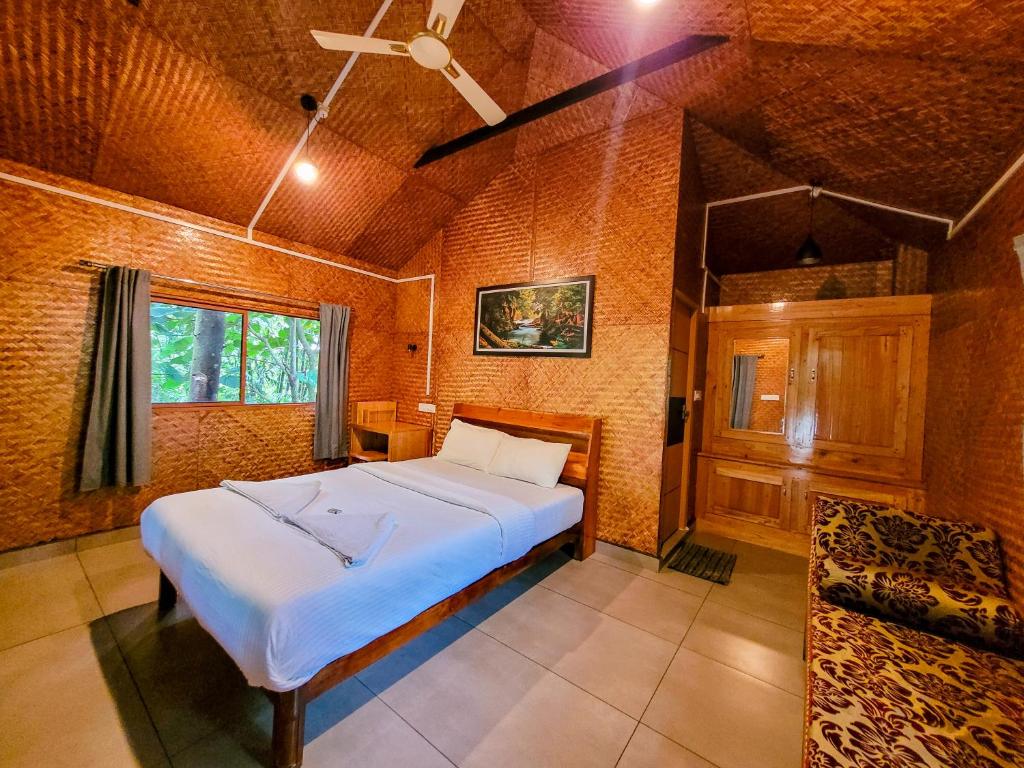 a bedroom with a large bed in a room at Monsoon Retreats Treehouse in Thekkady