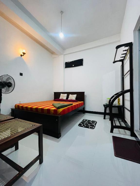 a bedroom with a bed in the corner of a room at Suriya Haven Homestay in Badulla