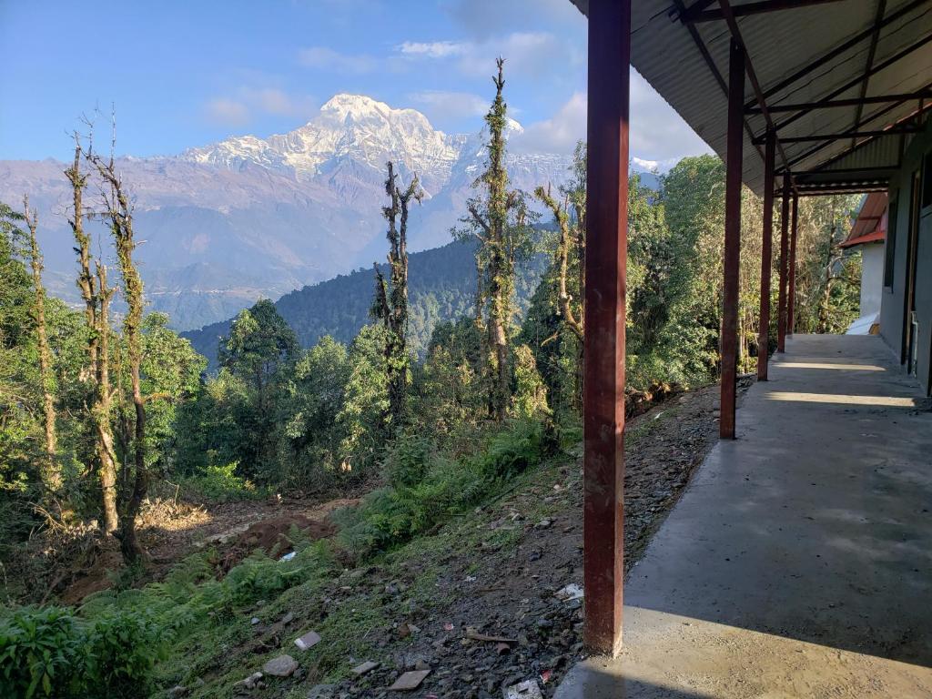 a porch of a house with a view of a mountain at Hotel mardi station and restaurent in Astam