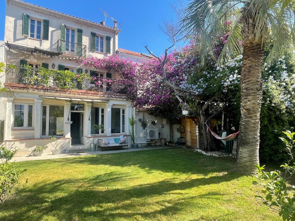une maison avec un palmier dans la cour dans l'établissement Maison au cœur du Mourillon avec Jacuzzi, à Toulon