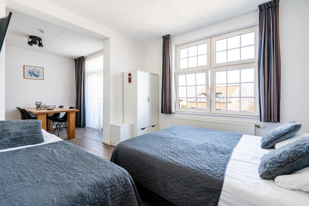 Postel nebo postele na pokoji v ubytování Duinhotel Haga