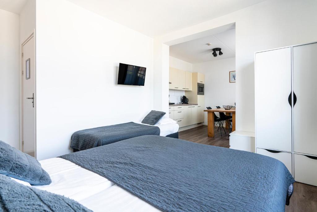 Postel nebo postele na pokoji v ubytování Duinhotel Haga