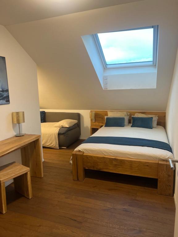 a bedroom with two beds and a skylight at Restaurant Hammer Highway-Grill in Lucerne