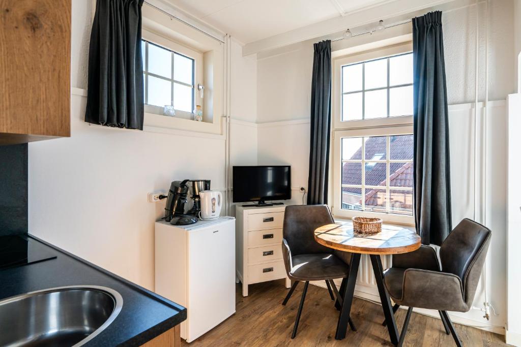 Kuchyň nebo kuchyňský kout v ubytování Duinhotel Haga