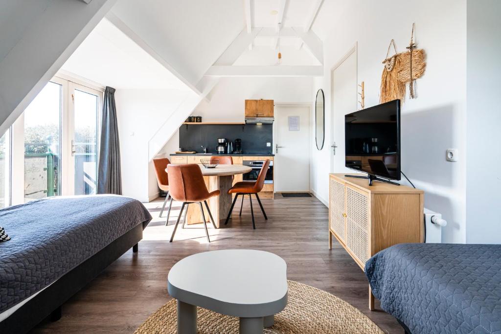TV a/nebo společenská místnost v ubytování Duinhotel Haga