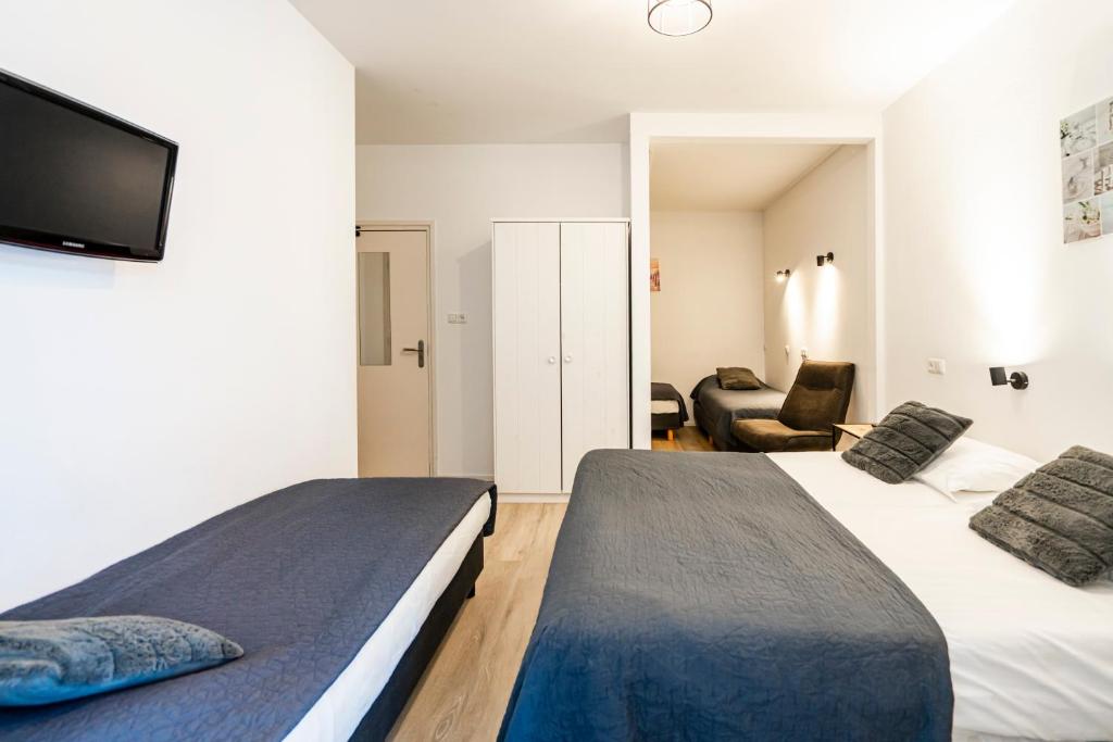 Postel nebo postele na pokoji v ubytování Duinhotel Haga