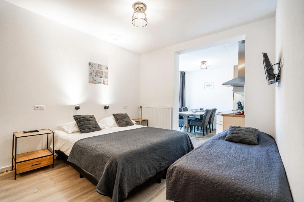 Postel nebo postele na pokoji v ubytování Duinhotel Haga