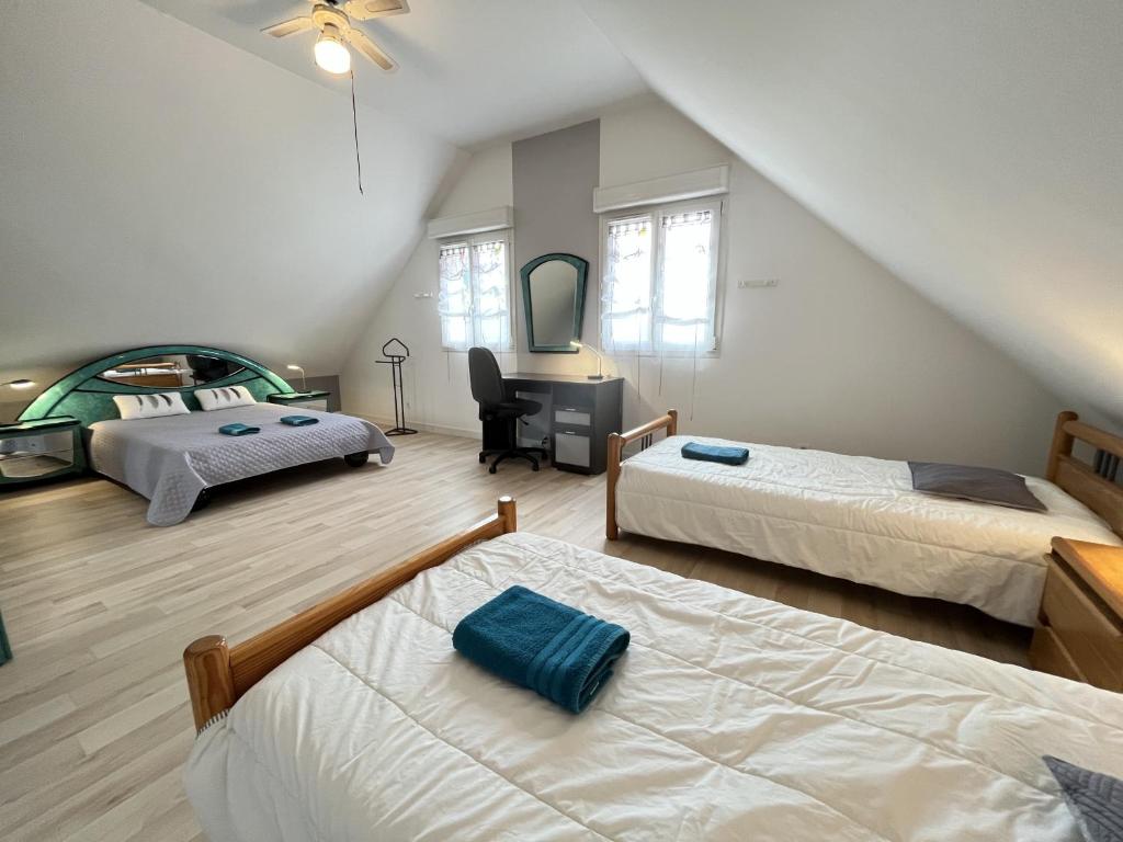a bedroom with three beds and a desk and a mirror at Villa Isaac - Piscine naturelle - Proche Boulerie Jump - 8p in Le Mans
