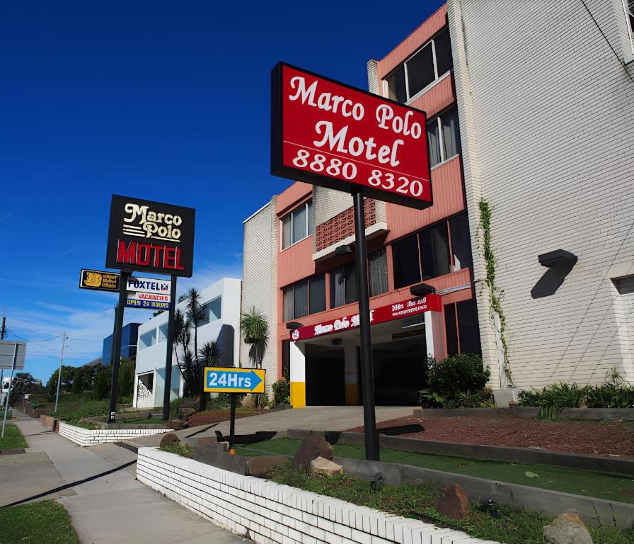 a motel sign in front of a building at Marco Polo Motor Inn Sydney Hotel in Sydney