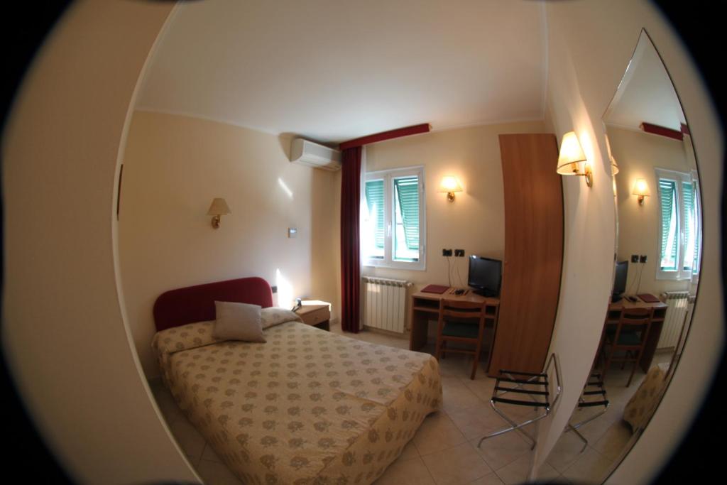 Postel nebo postele na pokoji v ubytování Hotel Stella