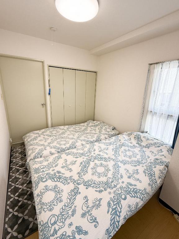 Postel nebo postele na pokoji v ubytování 大曽根駅から徒歩5分人工温泉が24時間楽しめてナゴヤドームまで徒歩で行く事が出来ます