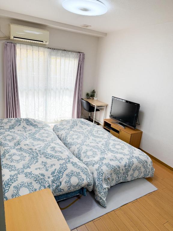 Postel nebo postele na pokoji v ubytování 大曽根駅から徒歩5分人工温泉が24時間楽しめてナゴヤドームまで徒歩で行く事が出来ます