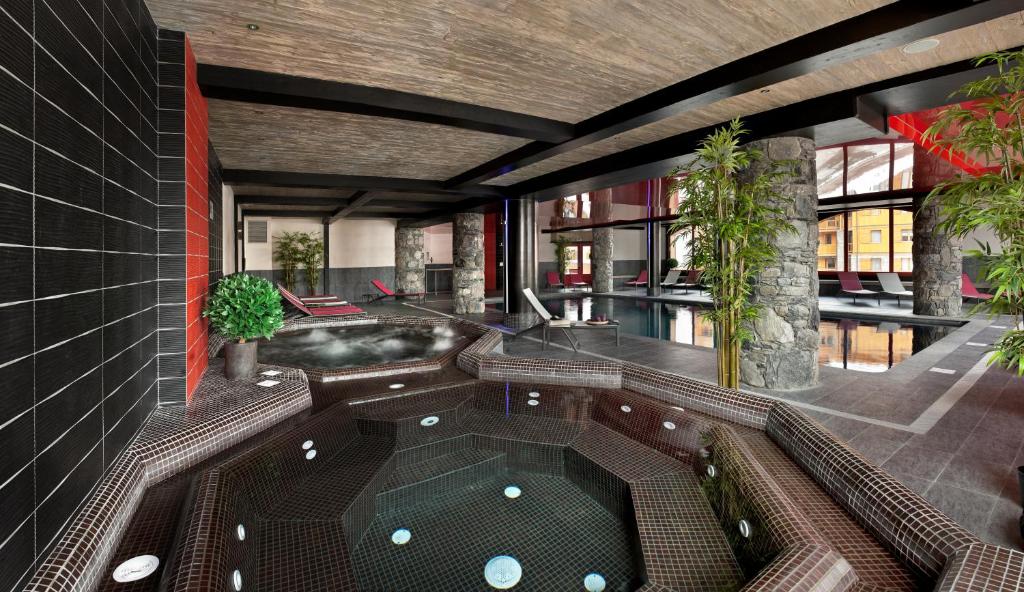 a room with a jacuzzi tub in a building at CGH Résidences & Spas Le Télémark in Tignes