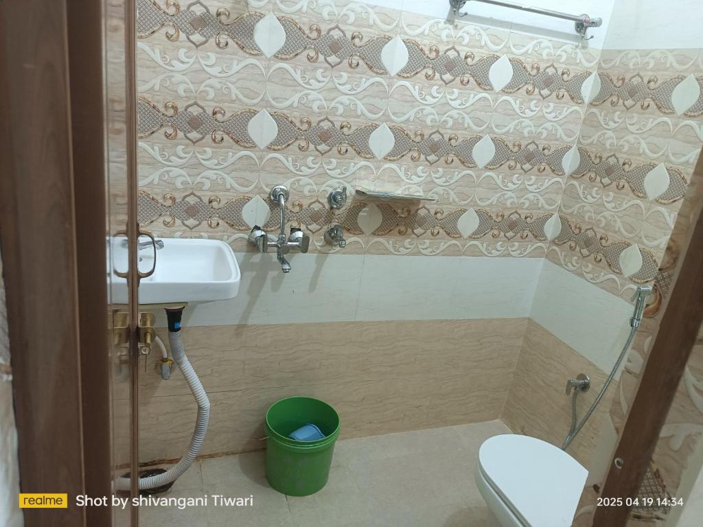 a bathroom with a sink and a toilet at Shri Ram Janam Homestay 300 Meter from Ram Mandir in Ayodhya